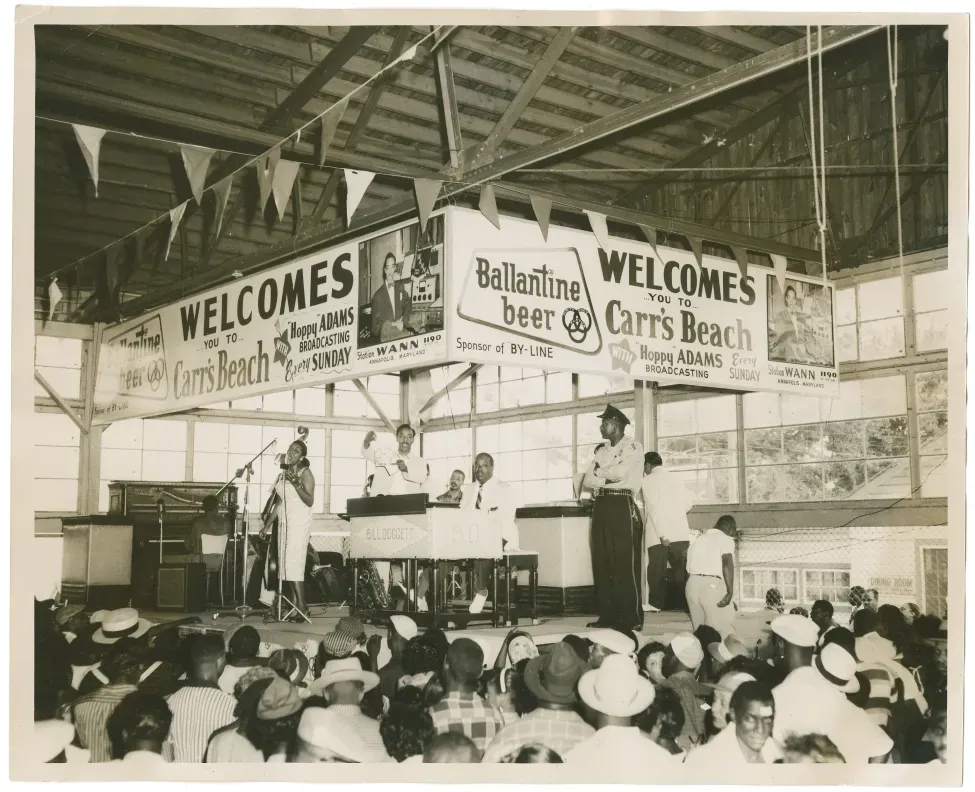 A live remote broadcast of the "Hoppy Adams" show on July 15, 1956, brought out people from Maryland and beyond to Carr’s Beach in Anne Arundel County, where many notable rhythm and blues musicians performed during the 1950s and 1960s. Hoppy Adams was an influential radio personality with WANN in Annapolis, Maryland, for over 40 years.