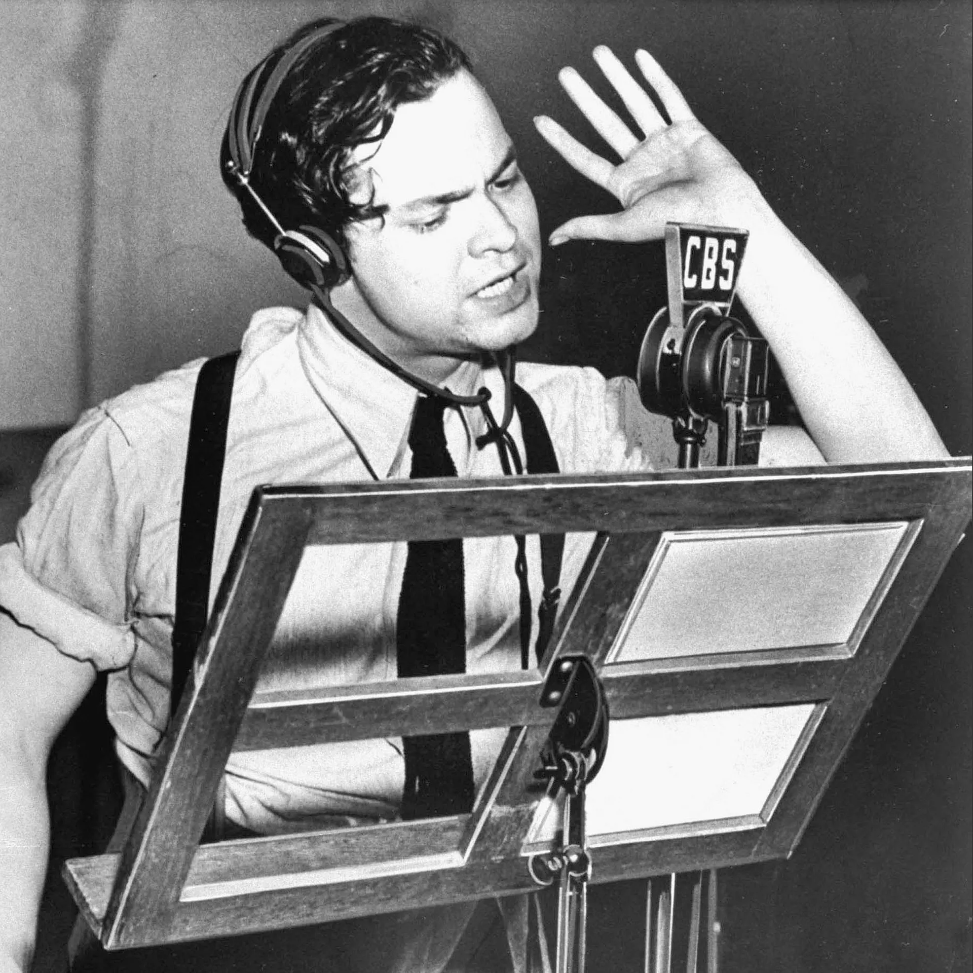 Orson Welles at the microphone during the 1938 broadcast of The War of the Worlds.
